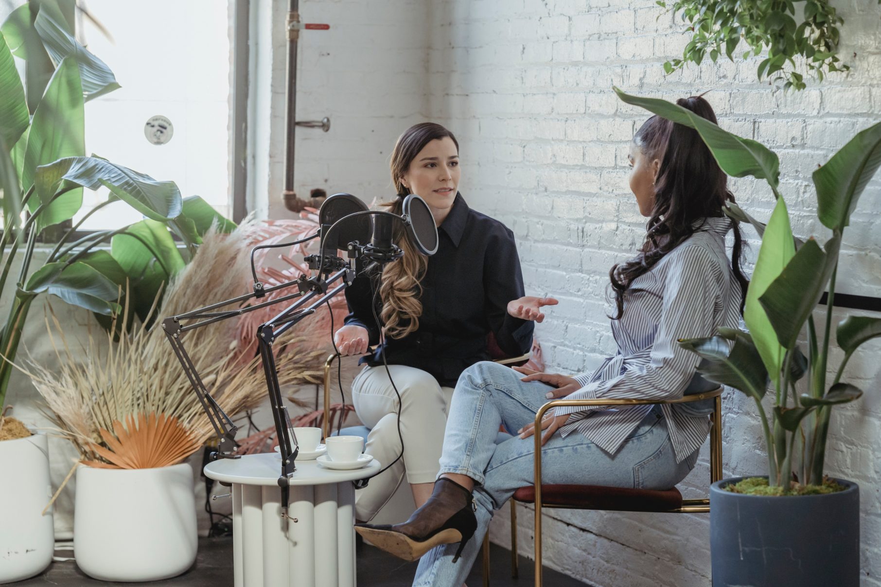 two woman filming a podcast